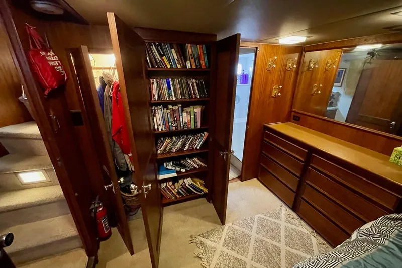 Slide: The Image of Interior of 1976 Hatteras 48 Long Range Cruiser with bookshelves and wooden cabinetry. - 51