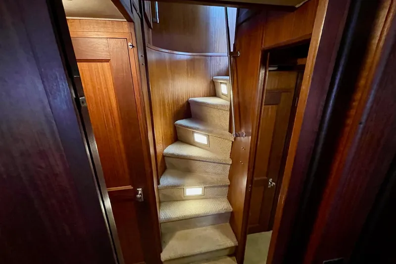 Slide: The Image of Interior staircase of 1976 Hatteras 48 Long Range Cruiser with wooden paneling and carpeted steps. - 52