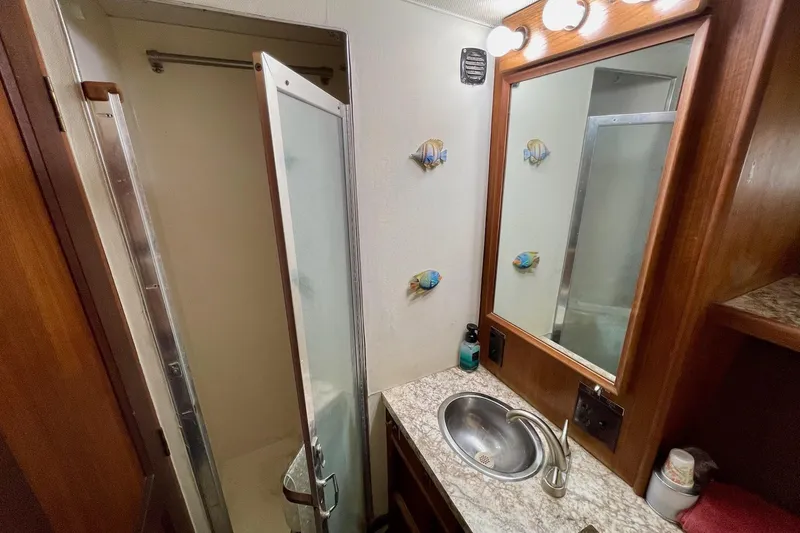 Slide: The Image of Bathroom interior of 1976 Hatteras 48 Long Range Cruiser with sink and shower. - 54