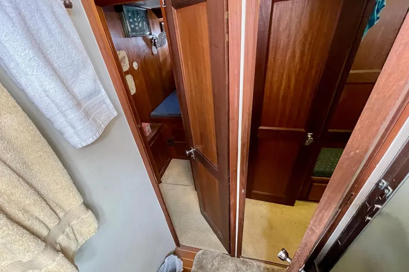 Slide: The Image of Interior view of 1976 Hatteras 48 Long Range Cruiser with wooden doors and cozy cabin. - 55
