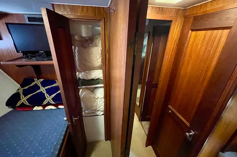 Slide: The Image of Interior of 1976 Hatteras 48 Long Range Cruiser with wood paneling and bunk beds. - 57