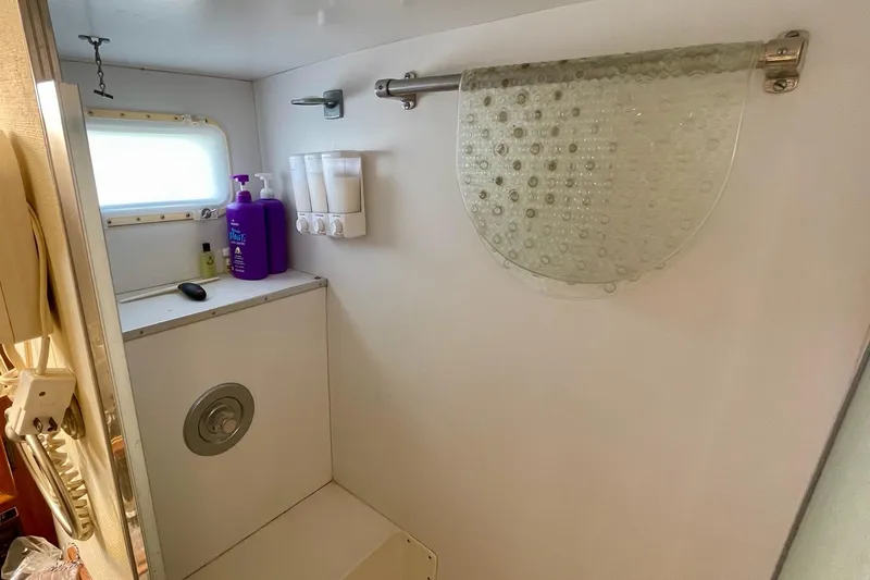 Slide: The Image of Bathroom interior of 1976 Hatteras 48 Long Range Cruiser with toiletries and window. - 59