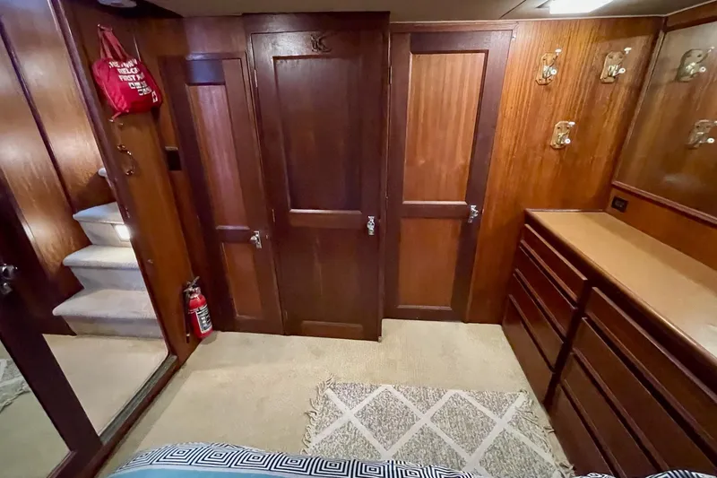 Slide: The Image of Interior of 1976 Hatteras 48 Long Range Cruiser with wood paneling and storage. - 61