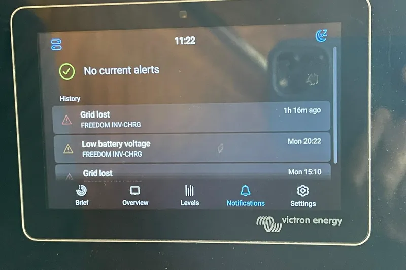 Slide: The Image of Victron Energy display showing alerts on a 1976 Hatteras 48 Long Range Cruiser. - 71