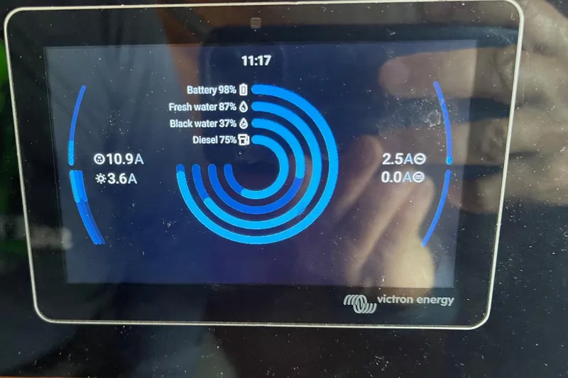 Slide: The Image of Victron Energy display showing battery and water levels on 1976 Hatteras 48 Long Range Cruiser. - 74