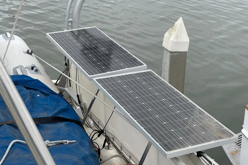 Slide: The Image of Solar panels on a 1976 Hatteras 48 Long Range Cruiser by the dock. - 76