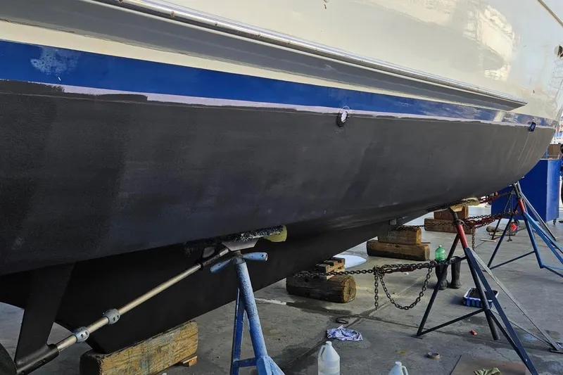 Slide: The Image of 1976 Hatteras 48 Long Range Cruiser undergoing maintenance on dry dock. - 80