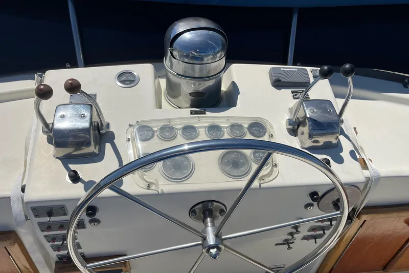 Slide: The Image of Helm of 1976 Hatteras 48 Long Range Cruiser with steering wheel and controls. - 9