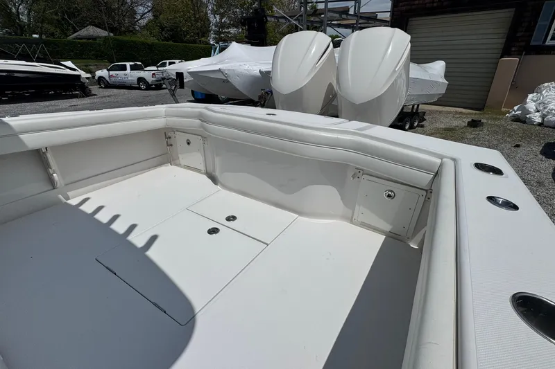 Slide: The Image of 2013 Jupiter 32 Cuddy boat interior with spacious seating and dual outboard engines. - 12