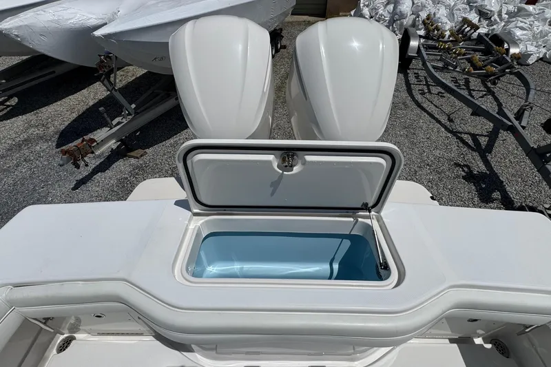 Slide: The Image of 2013 Jupiter 32 Cuddy boat with open storage compartment and dual outboard motors. - 13