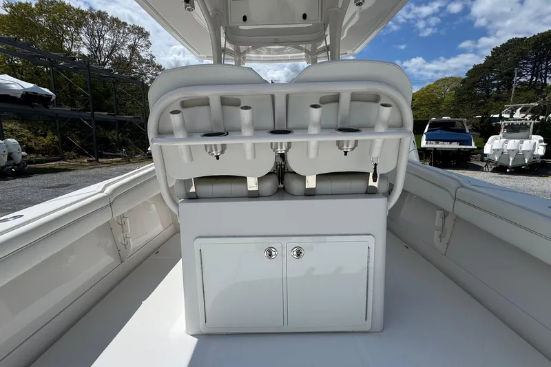 Slide: The Image of 2013 Jupiter 32 Cuddy boat interior with rod holders and storage compartments. - 17