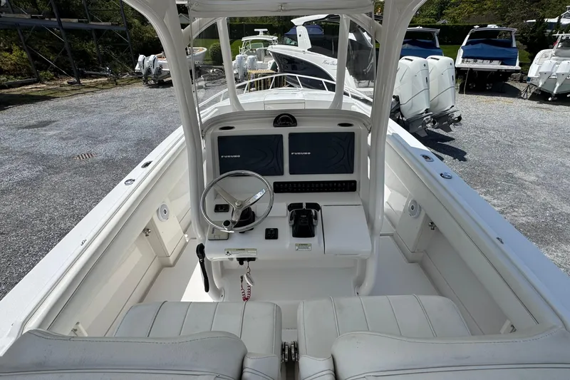 Slide: The Image of 2013 Jupiter 32 Cuddy boat cockpit with steering wheel and navigation system. - 19