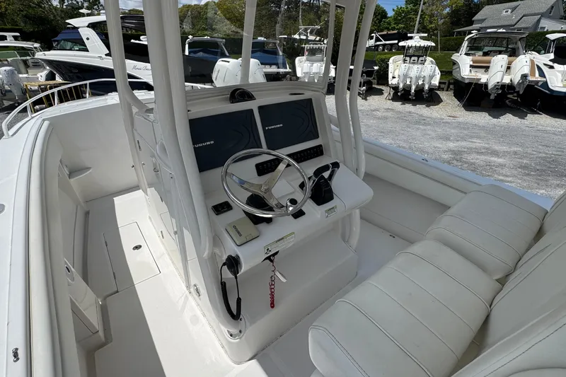 Slide: The Image of 2013 Jupiter 32 Cuddy boat cockpit with dual screens and plush seating. - 20