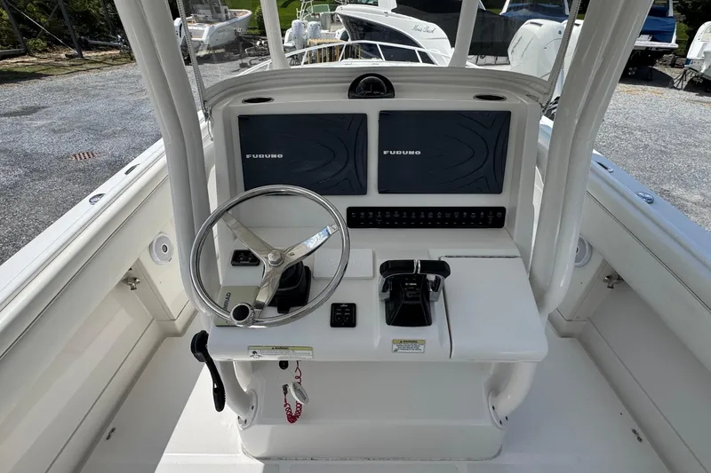 Slide: The Image of 2013 Jupiter 32 Cuddy helm with dual Furuno displays and steering wheel. - 22