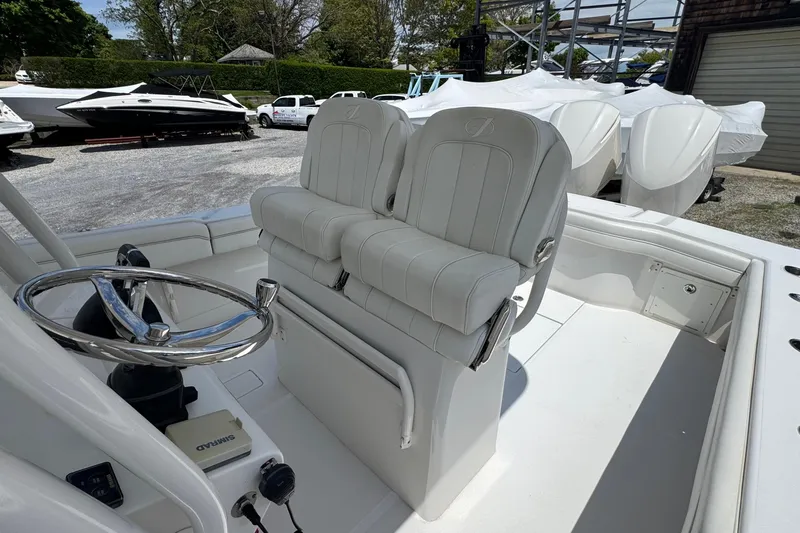 Slide: The Image of 2013 Jupiter 32 Cuddy boat interior with dual helm seats and steering wheel. - 23