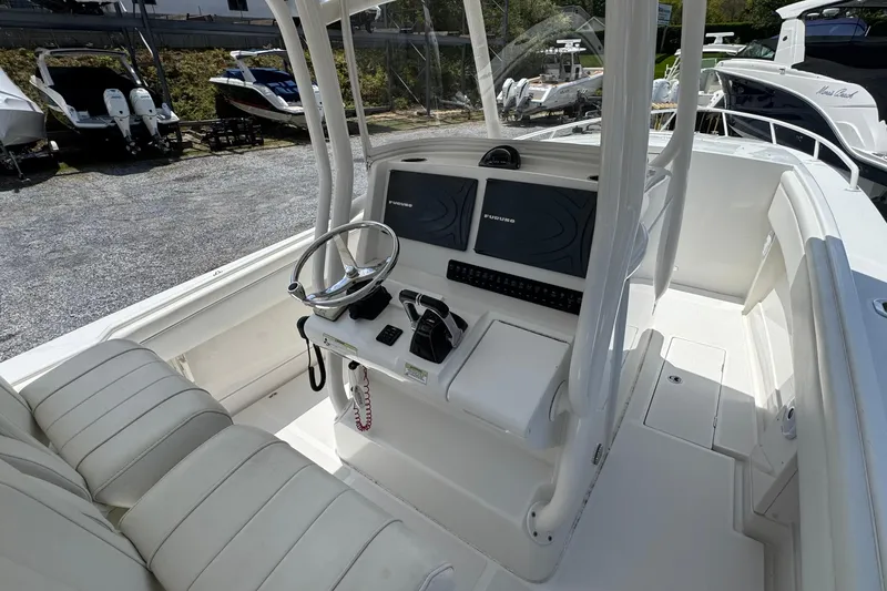Slide: The Image of 2013 Jupiter 32 Cuddy boat cockpit with steering wheel and navigation system. - 24