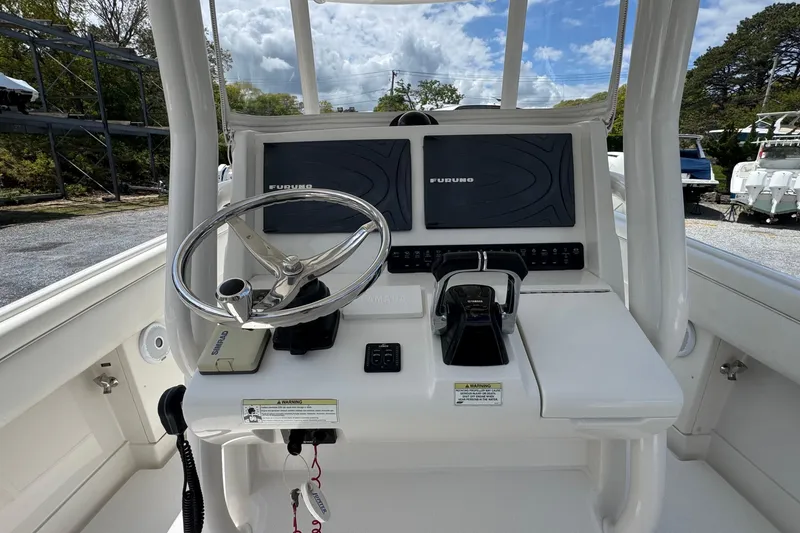 Slide: The Image of Helm of 2013 Jupiter 32 Cuddy boat with steering wheel and Furuno navigation system. - 25