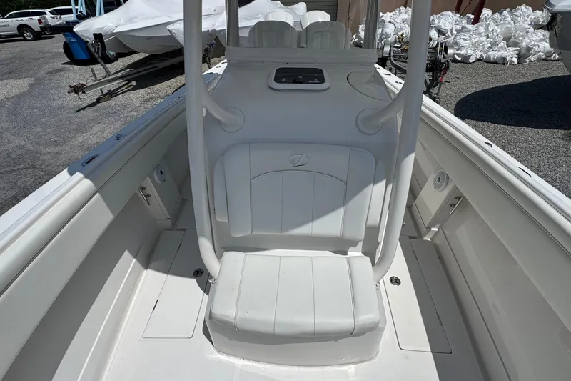 Slide: The Image of 2013 Jupiter 32 Cuddy boat interior with white seating and storage compartments. - 27