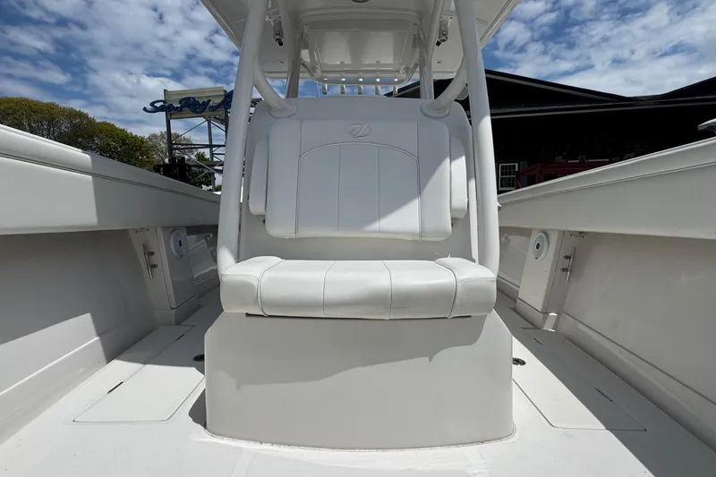 Slide: The Image of 2013 Jupiter 32 Cuddy boat interior with white seating under a blue sky. - 28