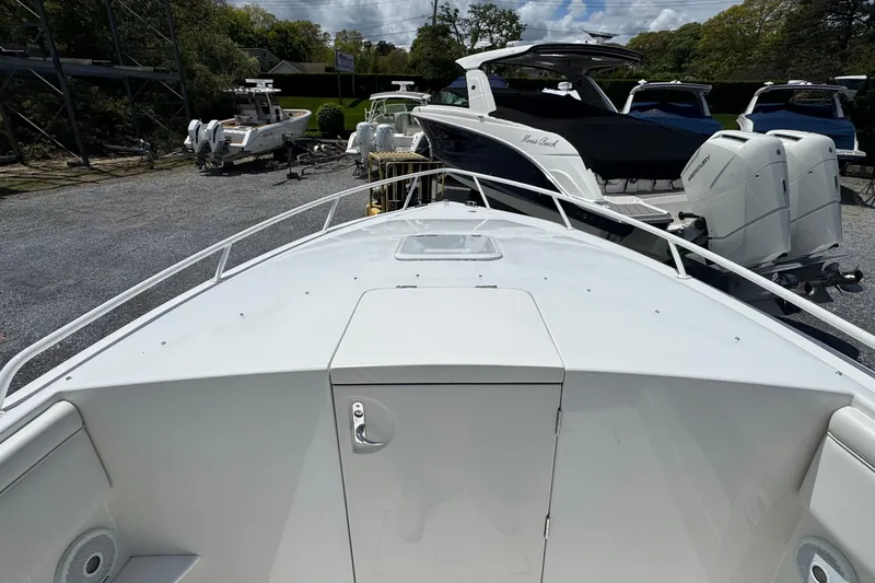 Slide: The Image of 2013 Jupiter 32 Cuddy boat in a marina, surrounded by other vessels and trailers. - 30