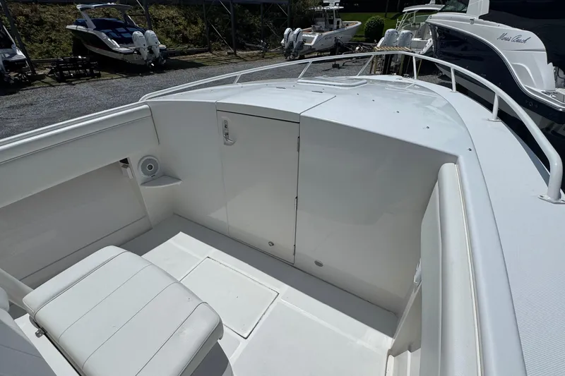 Slide: The Image of 2013 Jupiter 32 Cuddy boat interior with white seating and storage compartment. - 31