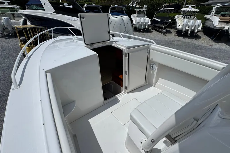 Slide: The Image of 2013 Jupiter 32 Cuddy boat interior with open cabin door, showcasing seating and deck area. - 33