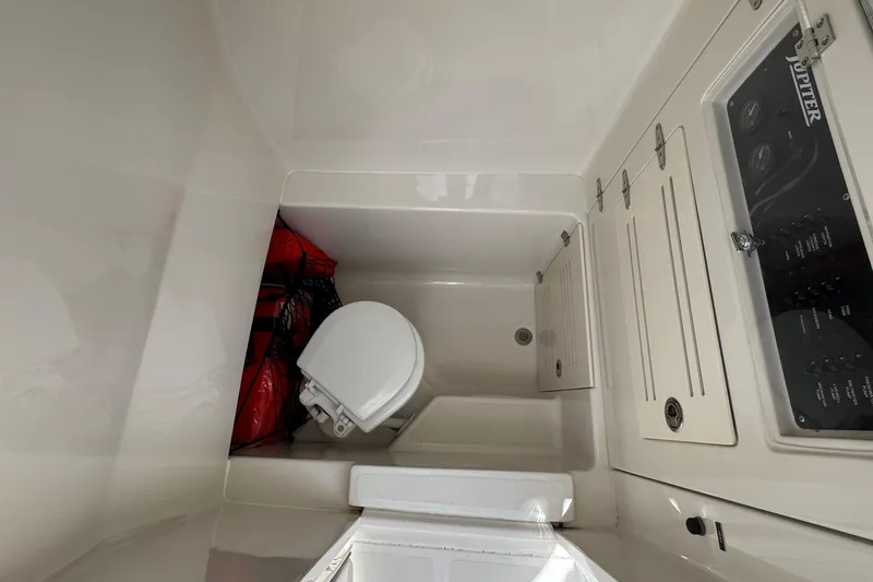 Slide: The Image of 2013 Jupiter 32 Cuddy boat interior with toilet and storage compartments. - 43