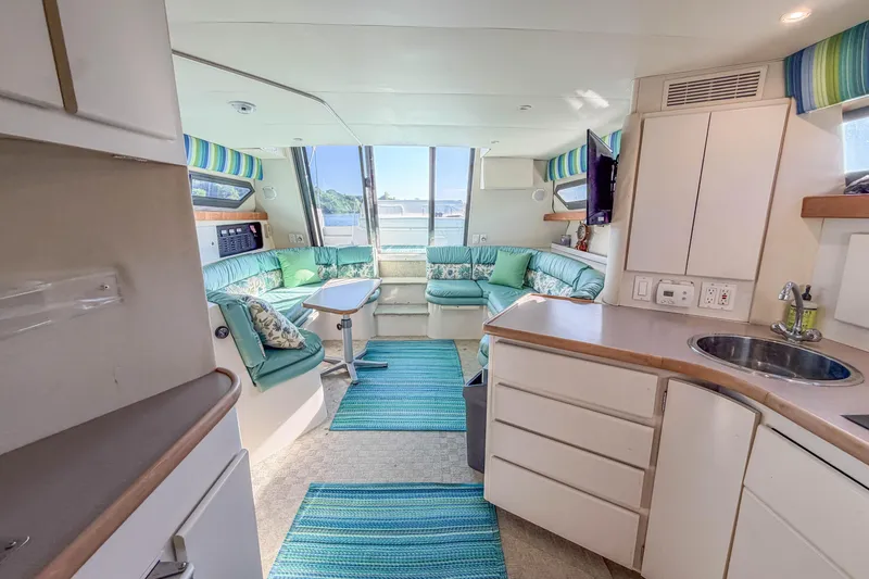 Slide: The Image of Interior of 1994 Carver 380 Santego yacht with modern kitchen and cozy seating area. - 29