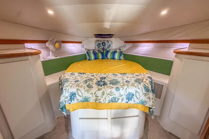 Slide: The Image of Cozy cabin interior of 1994 Carver 380 Santego with floral bedding and modern decor. - 32