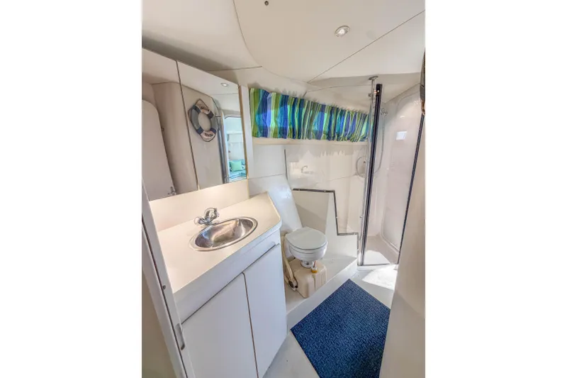Slide: The Image of Bathroom interior of 1994 Carver 380 Santego yacht with sink, toilet, and shower. - 33