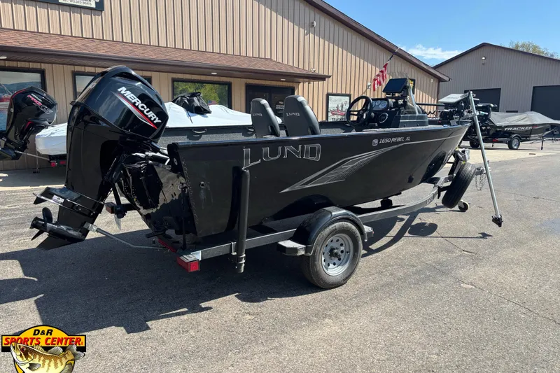 Slide: The Image of 2023 Lund 1650 Rebel XL SS boat with Mercury engine on trailer at dealership. - 2