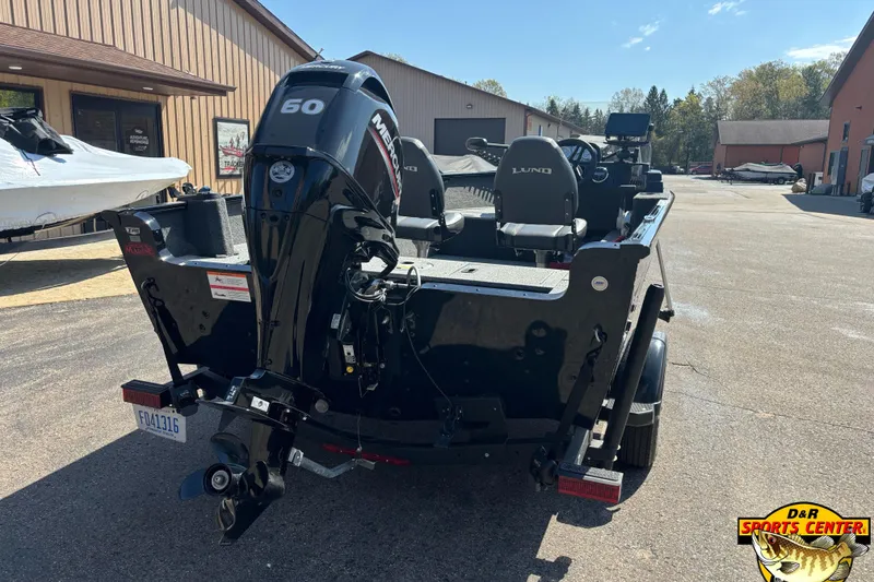 Slide: The Image of 2023 Lund 1650 Rebel XL SS boat with Mercury 60 engine, parked outdoors. - 3