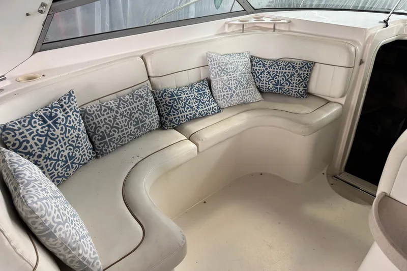 Slide: The Image of 2002 Rinker Fiesta Vee 310 boat interior with cushioned seating and patterned pillows. - 11