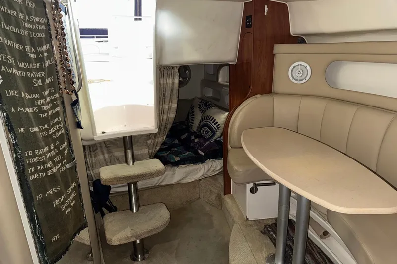 Slide: The Image of Interior of 2002 Rinker Fiesta Vee 310 boat with seating and sleeping area. - 16