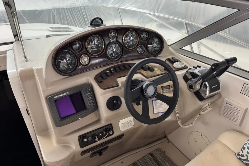 Slide: The Image of Cockpit of 2002 Rinker Fiesta Vee 310 with steering wheel and instrument panel. - 2