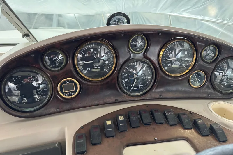 Slide: The Image of Dashboard of a 2002 Rinker Fiesta Vee 310 boat with gauges and controls. - 5