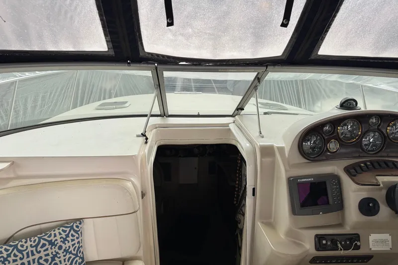 Slide: The Image of 2002 Rinker Fiesta Vee 310 boat cockpit with navigation instruments and seating. - 6