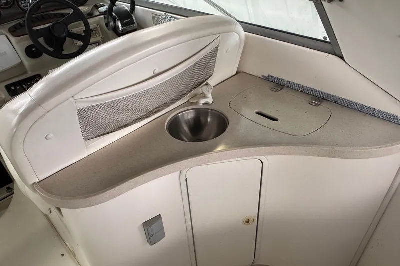 Slide: The Image of 2002 Rinker Fiesta Vee 310 boat interior with sink and storage area. - 8