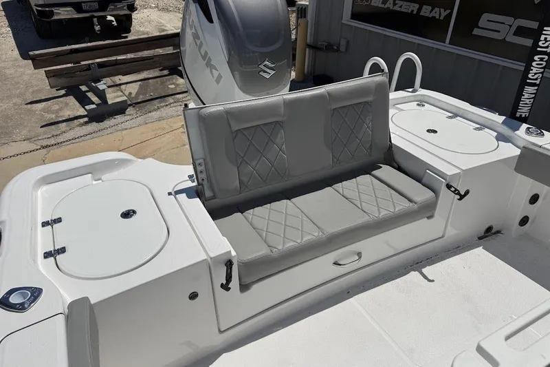 Slide: The Image of 2026 Blazer Bay Makaira 2600 boat interior with gray cushioned seating and storage compartments. - 12