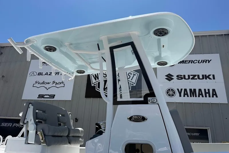 Slide: The Image of 2026 Blazer Bay Makaira 2600 boat with T-top and seating, displayed outdoors. - 4