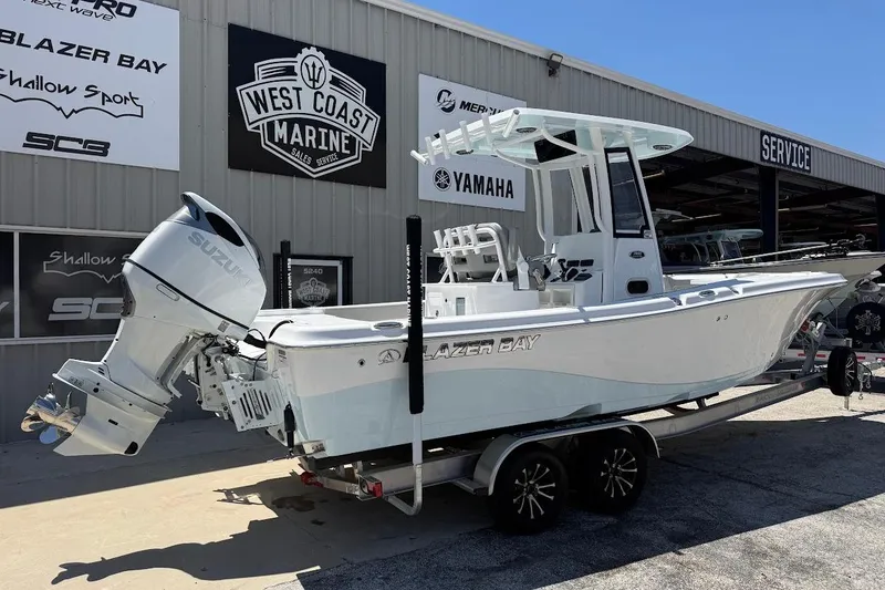 Slide: The Image of 2026 Blazer Bay Makaira 2600 boat with Suzuki engine at West Coast Marine dealership. - 6