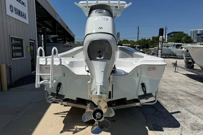 Slide: The Image of 2026 Blazer Bay Makaira 2600 boat with powerful outboard motor, displayed at a marina. - 7