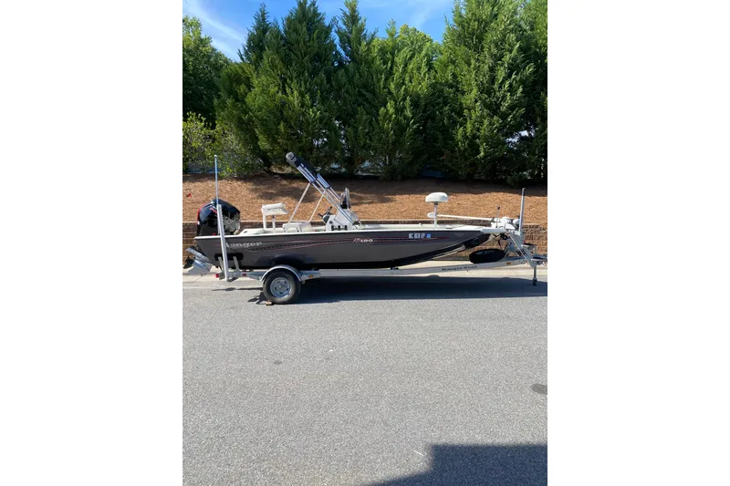The Image of 2020 Ranger RB190 boat on trailer, parked on road with trees in background. - 0