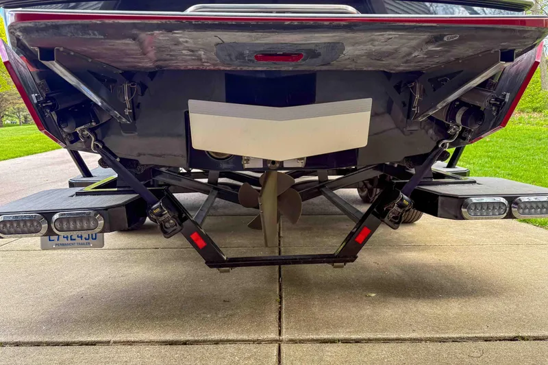 Slide: The Image of Rear view of a 2016 Axis A22 boat on a trailer, showcasing propeller and platform. - 10