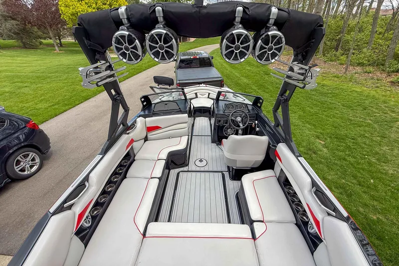 Slide: The Image of 2016 Axis A22 boat interior with seating, speakers, and steering wheel. - 12