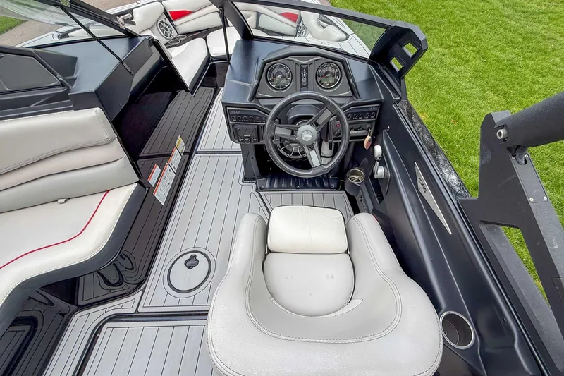 Slide: The Image of Interior of 2016 Axis A22 boat with steering wheel and seating. - 18