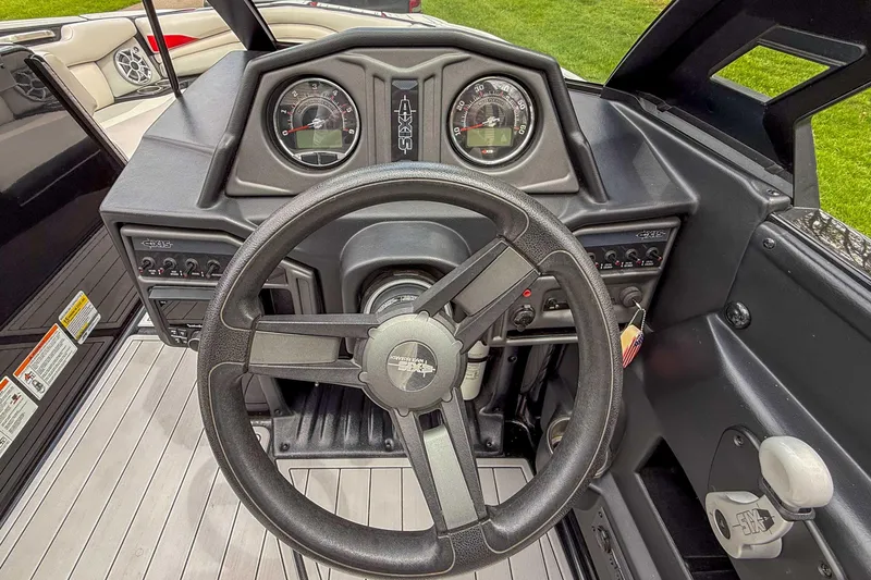 Slide: The Image of 2016 Axis A22 boat dashboard with steering wheel and instrument panel. - 19