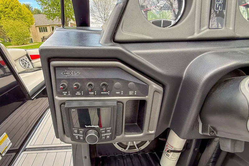 Slide: The Image of Control panel of a 2016 Axis A22 boat with switches and a Rockford Fosgate audio system. - 20