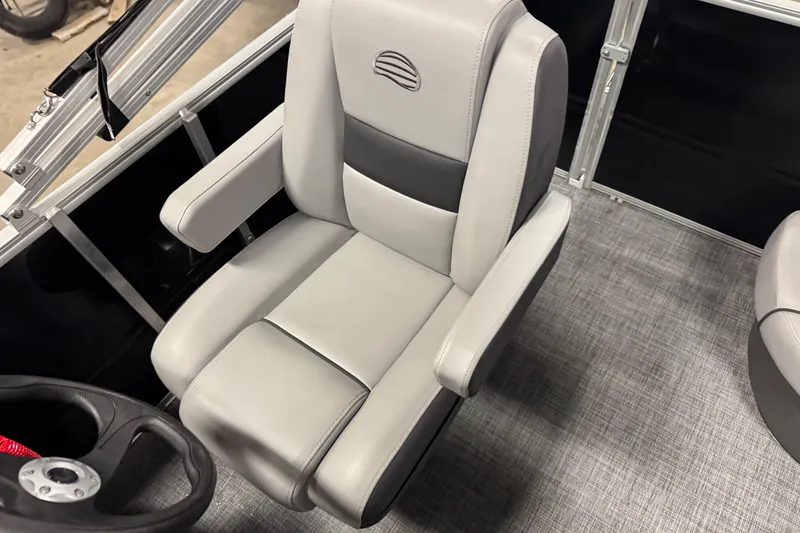 Slide: The Image of Captain's chair in 2026 Sun Tracker Party Barge 16 DLX, featuring sleek gray upholstery. - 14