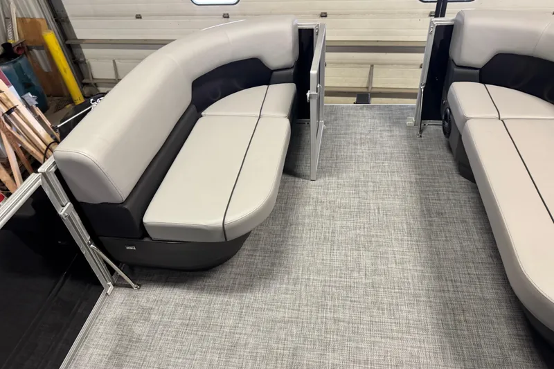 Slide: The Image of 2026 Sun Tracker Party Barge 16 DLX interior with gray seating and flooring. - 6